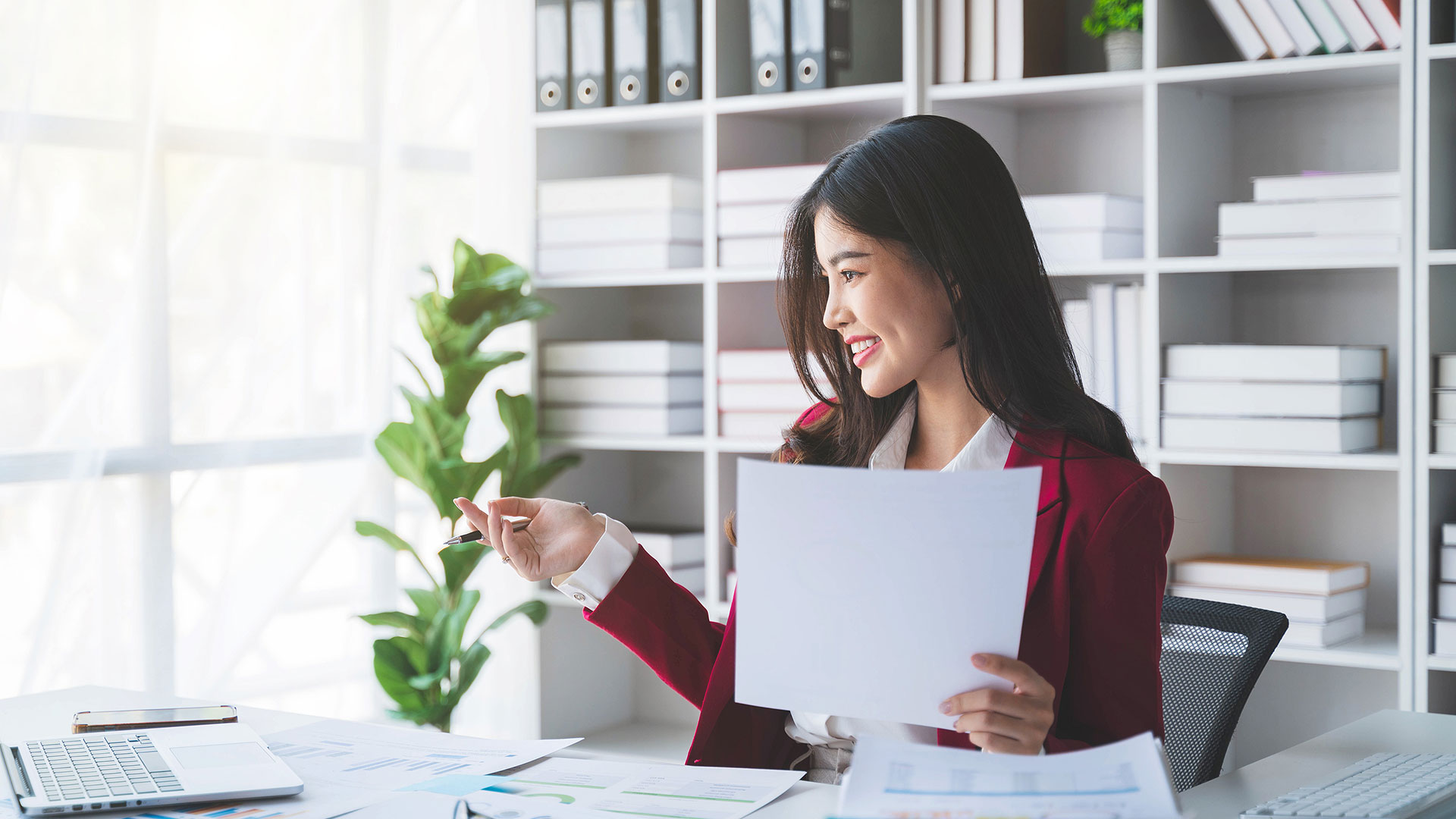 person holding papers sitting in an office